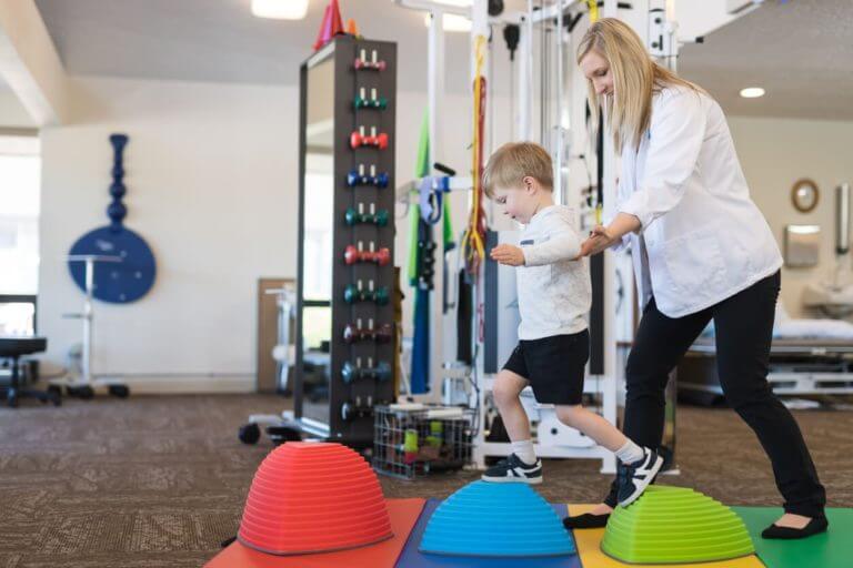 pediatric physical therapist working with child on balance