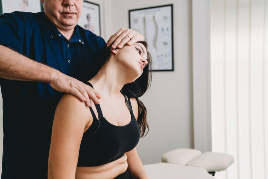 Physical therapy treatment on a young woman's neck