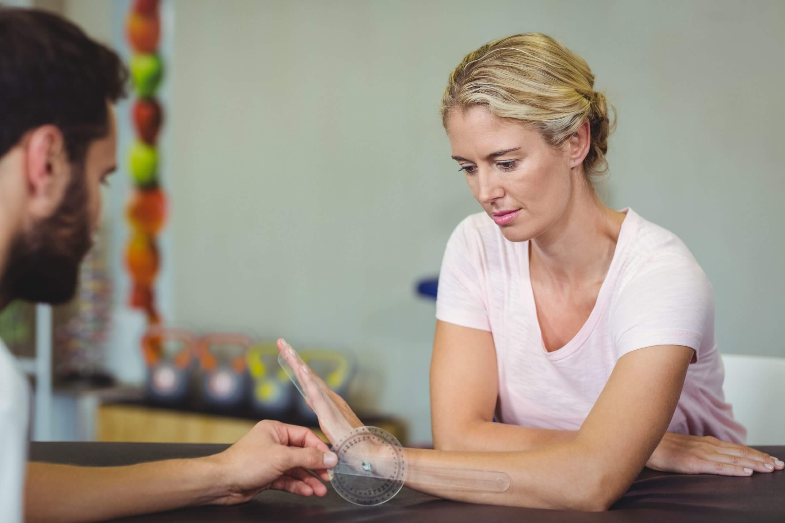 hand therapist working with patient