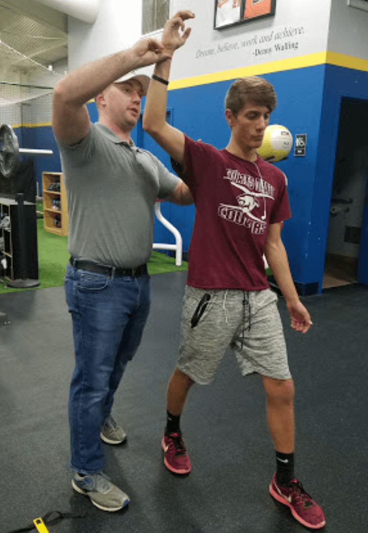 physical therapist helping thrower with arm pain