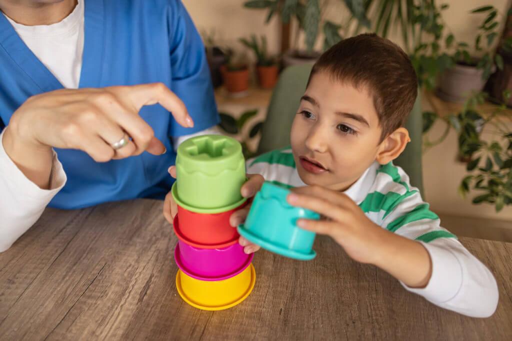 A child participating in sensory activities with a therapist during a pediatric occupational therapy session.