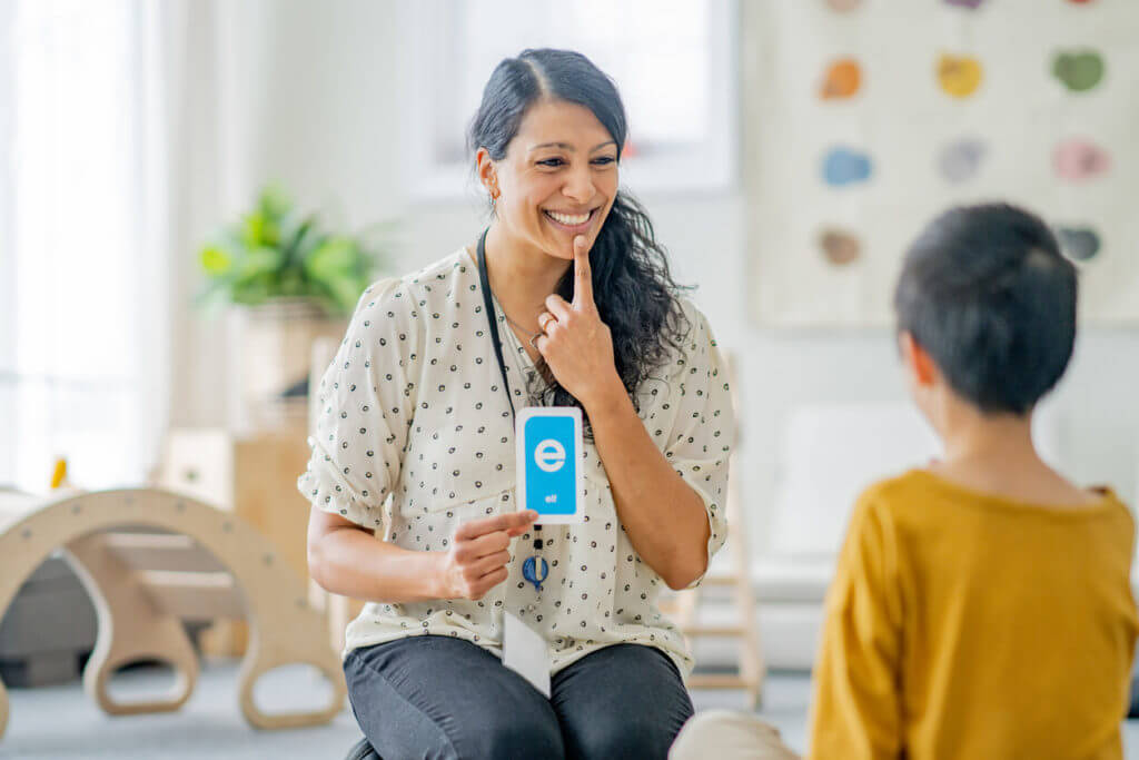 A children's speech therapy session featuring a female speech therapist working with a young girl.